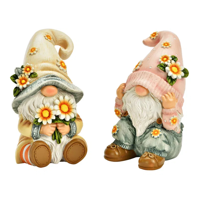 Two decorative gonks with floral hats and bouquets on a white background