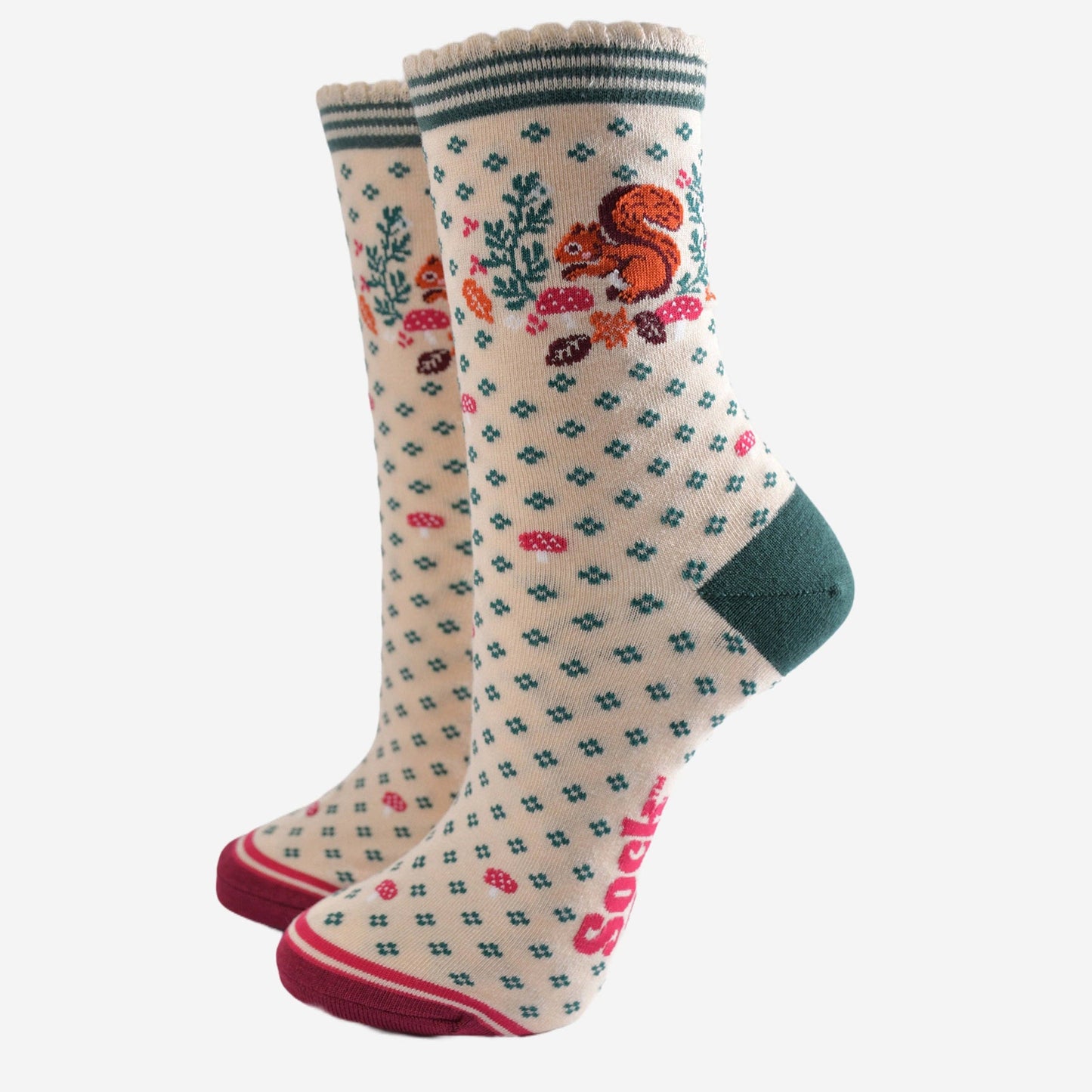 Pair of socks with a pattern of a squirrel and foliage on a white background
