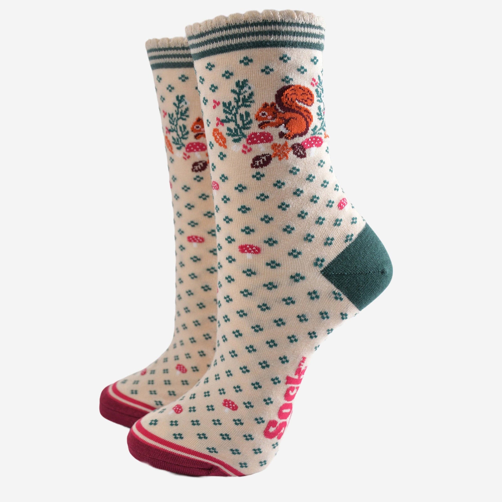 Pair of socks with a pattern of a squirrel and foliage on a white background
