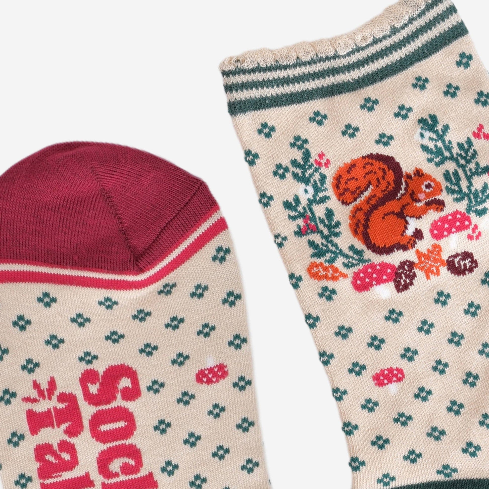 Pair of socks with a squirrel design on a beige background