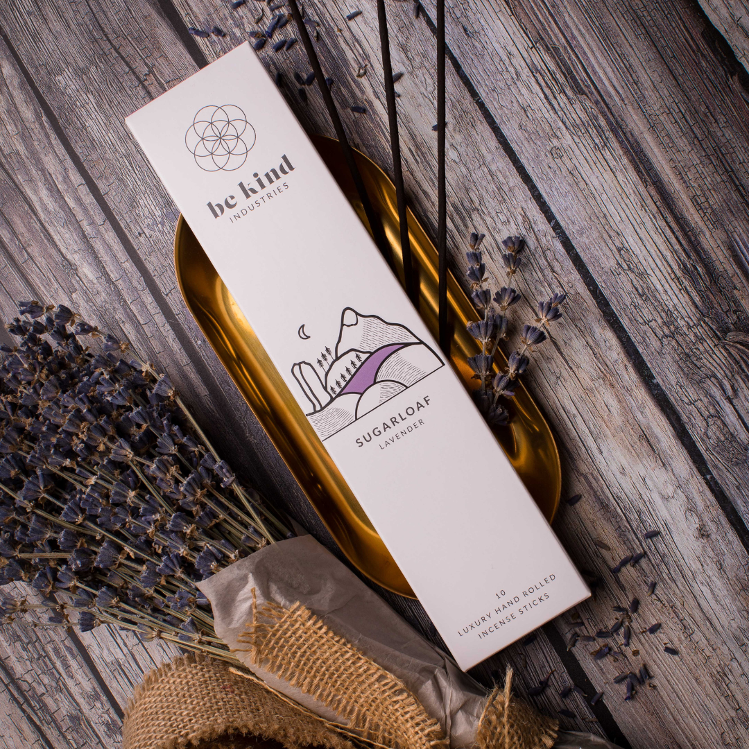 Be Kind Industries incense stick packaging on a wooden surface with lavender.