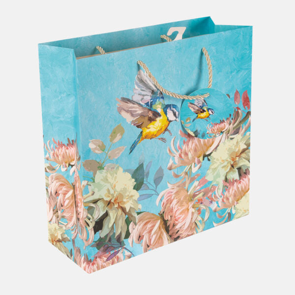 Floral and bird-themed gift bag on a white background