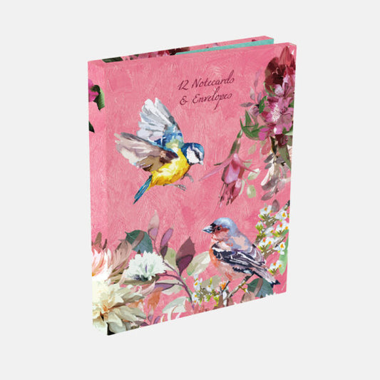 Notebook with bird and floral design on a pink background