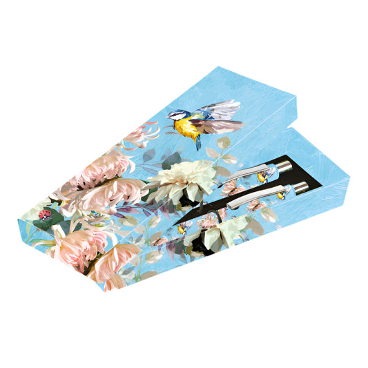 Floral and bird design on a blue background with a pen and clip set.