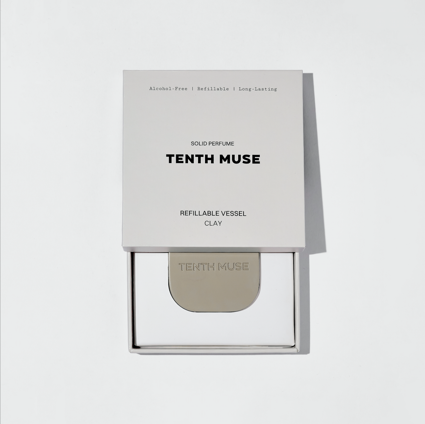 Tenth Muse solid perfume packaging on a light gray background
