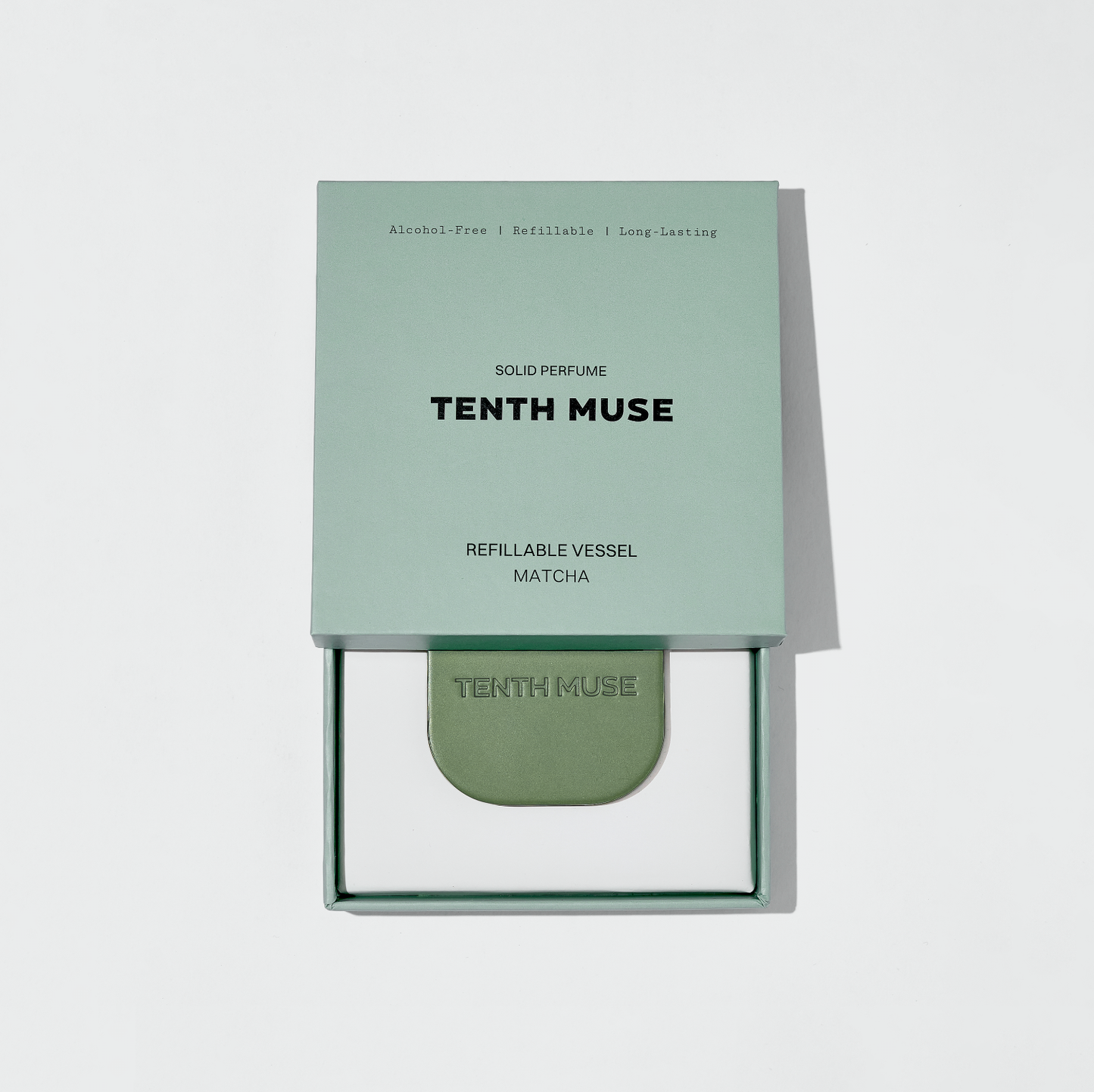 Tenth Muse solid perfume packaging on a light gray background