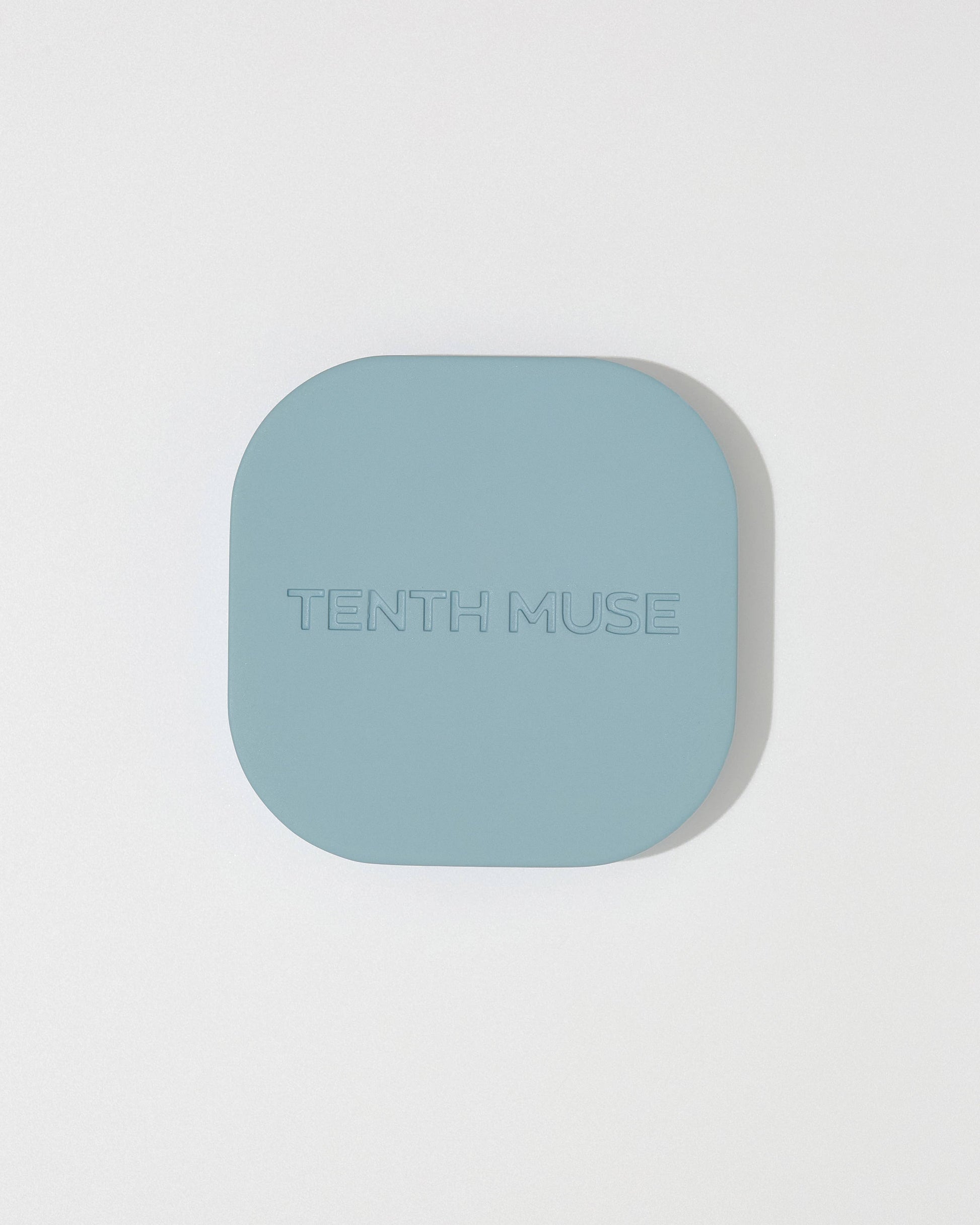  Tenth Muse metal perfume balm holder  on a light gray background