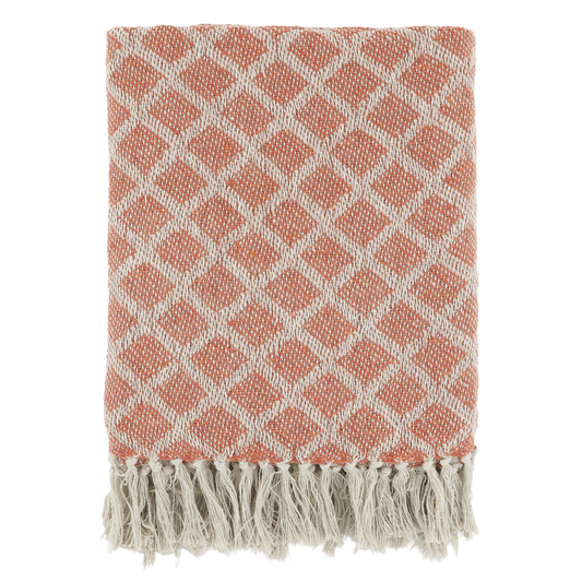 Pink and white diamond patterned throw blanket with fringes on a white background