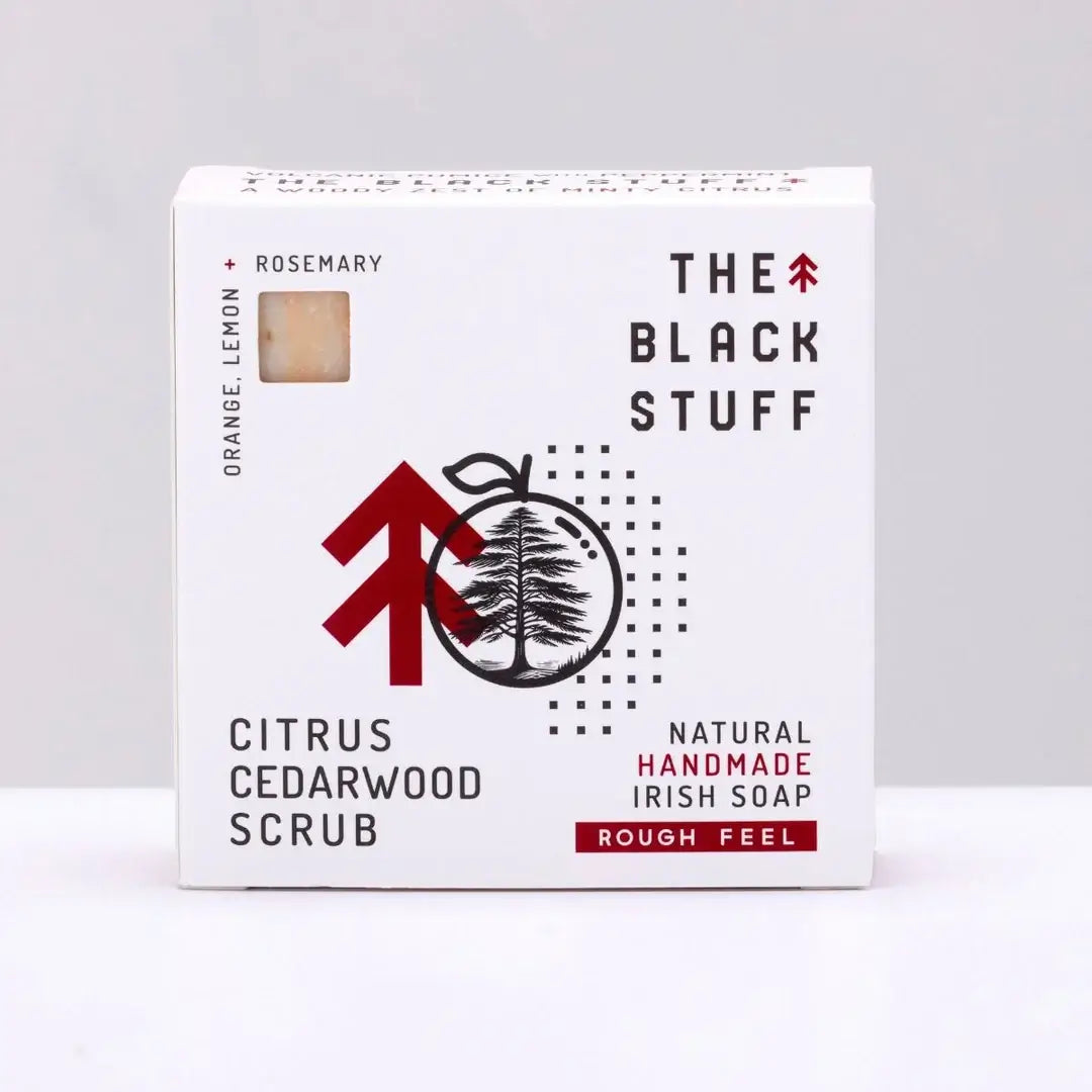 Packaging of 'The Black Stuff' Citrus Cedarwood Scrub bar soap, with the brand's logo and product details, indicating it is a rough feel product with a citrus scent.