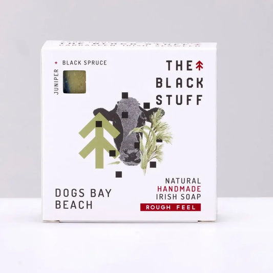 Packaging for 'The Black Stuff' Dogs Bay Beach bar soap, featuring the product name, a small amount of soap, and a rough feel description.