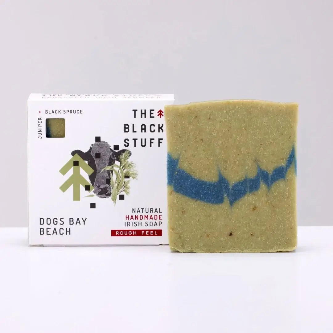 Packaging for 'The Black Stuff' Dogs Bay Beach bar soap, featuring the product name, a small amount of soap, and a rough feel description.