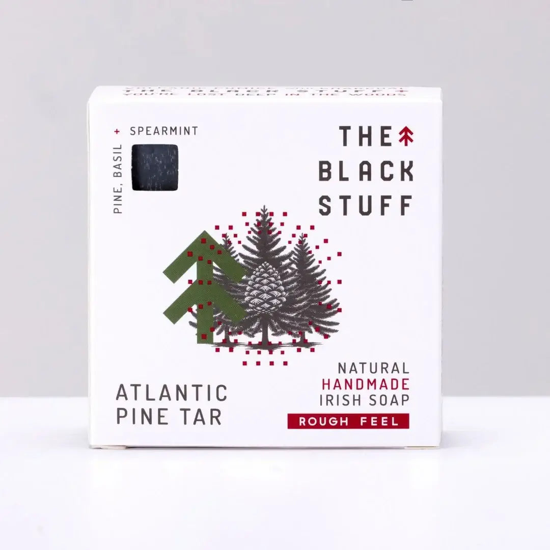 Packaging for 'The Black Stuff' Atlantic Pine Tar bar soap, featuring the product name, a small amount of soap, and a rough feel description.