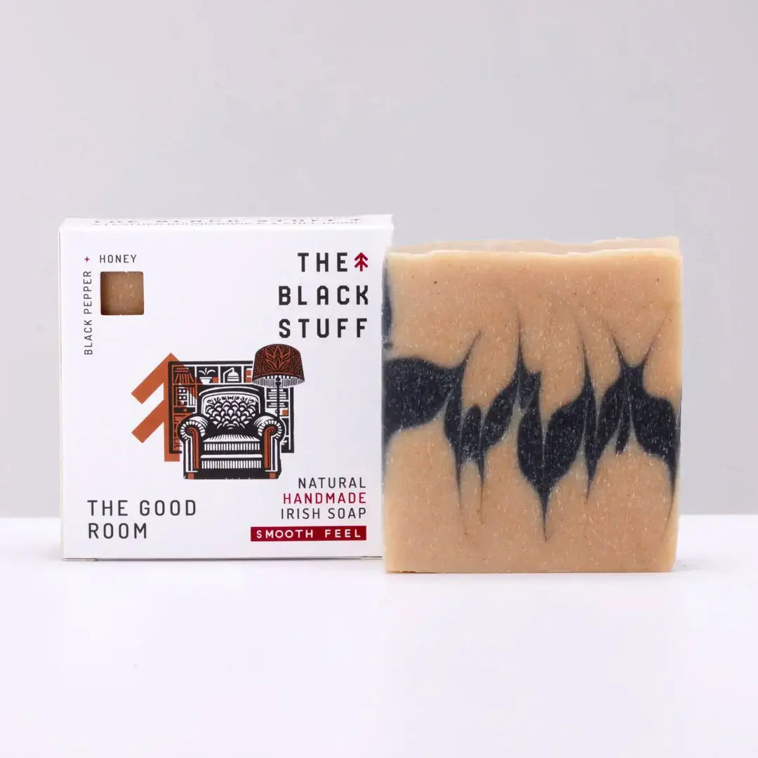 The Black Stuff Soap-The Good Room soap bar sitting by its box on a white background