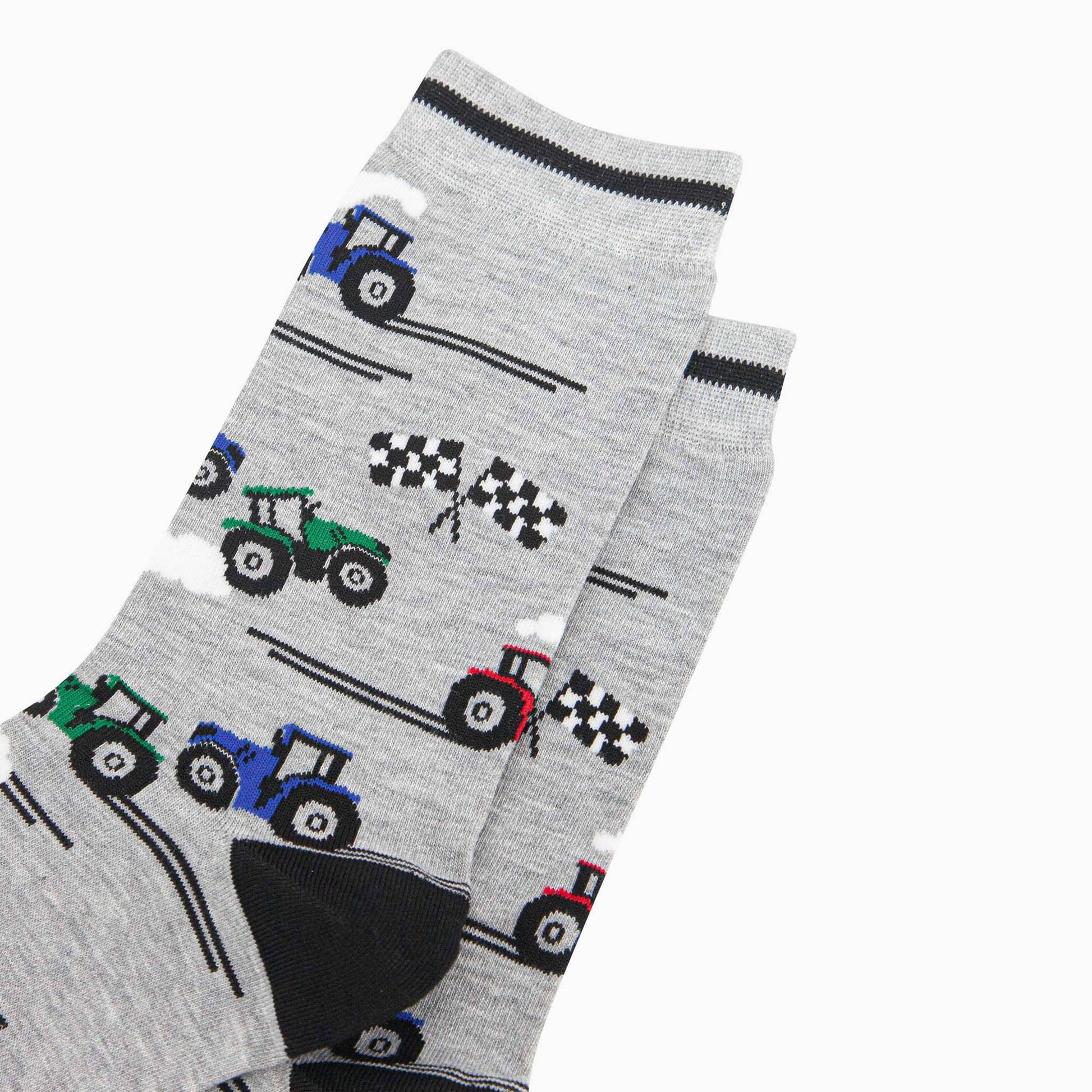 Gray socks with tractor patterns on a white background