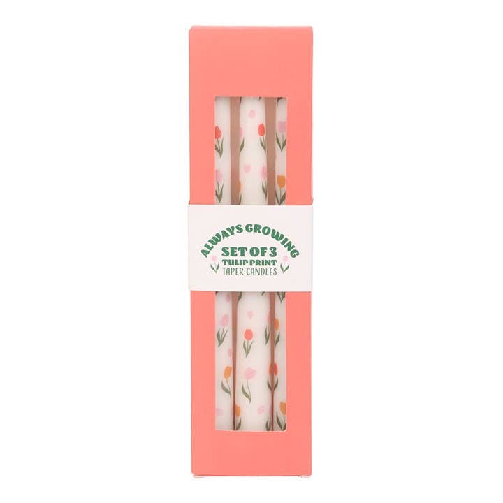 Set of three tulip print taper candles in a pink box with a white label.