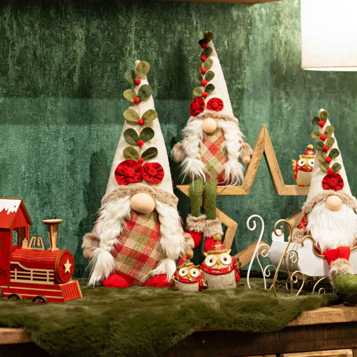 Decorative Christmas gnomes with a green textured wall background