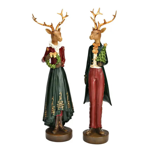 Two deer statues in formal attire with decorative clothing on a white background