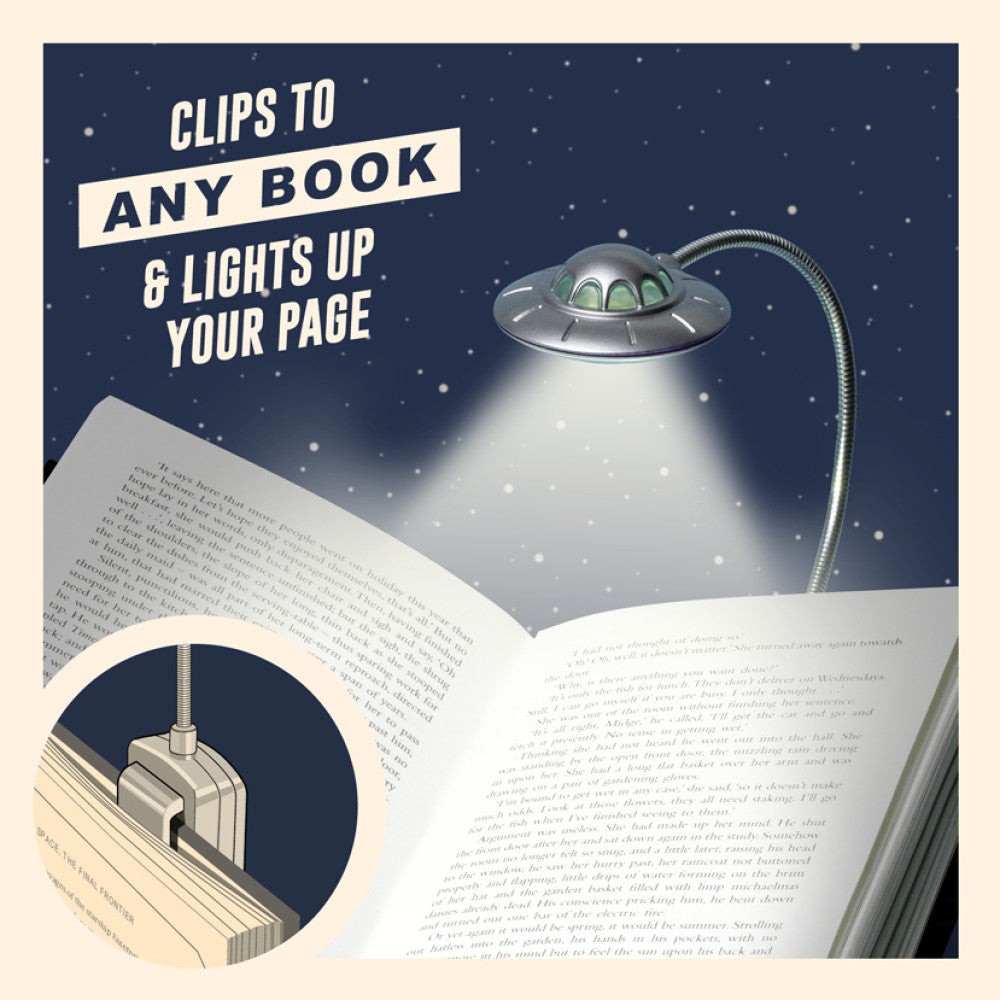 UFO-shaped book light clips to any book and lights up your page with a night sky background.