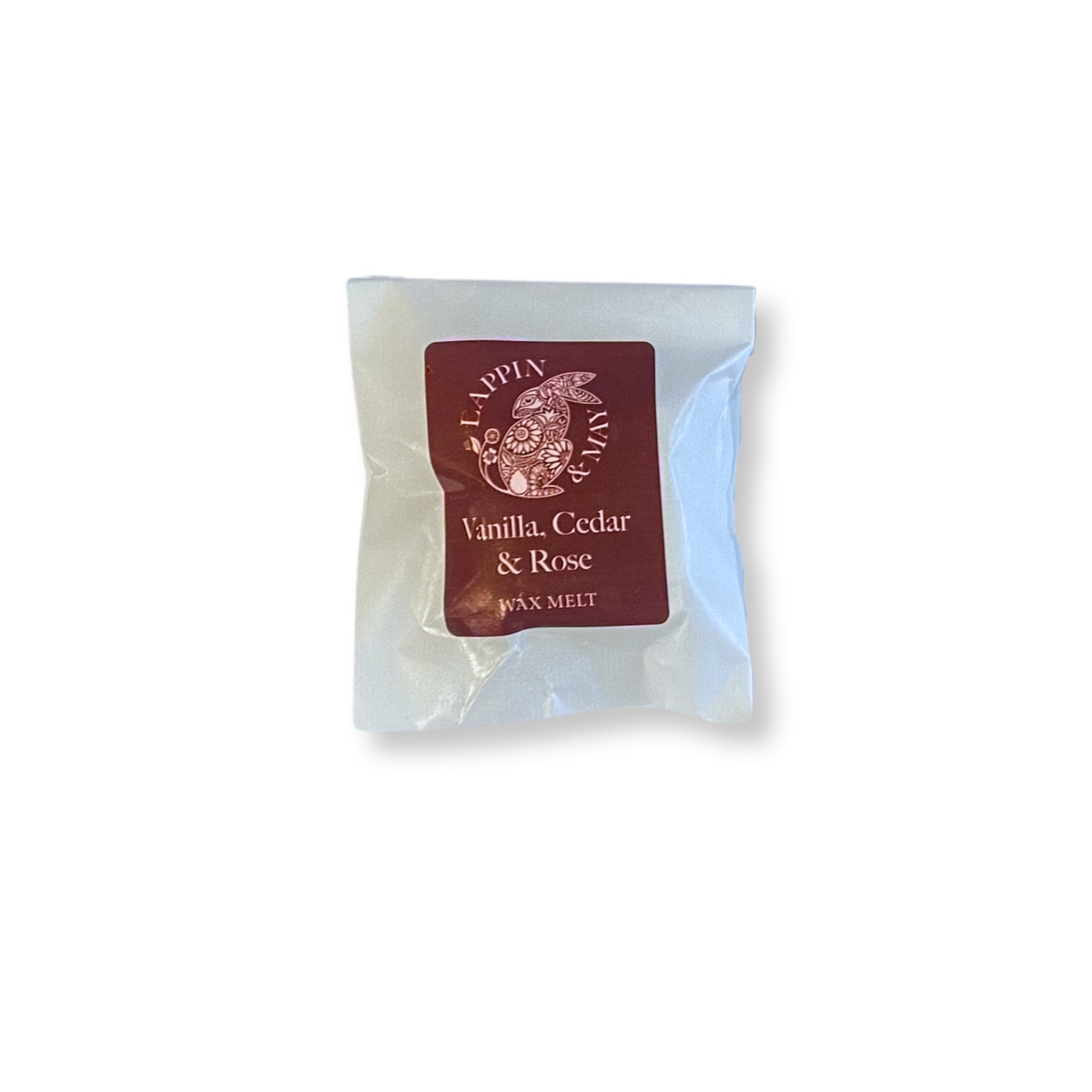 Wax melt package labeled 'Vanilla, Cedar & Rose' on a white background