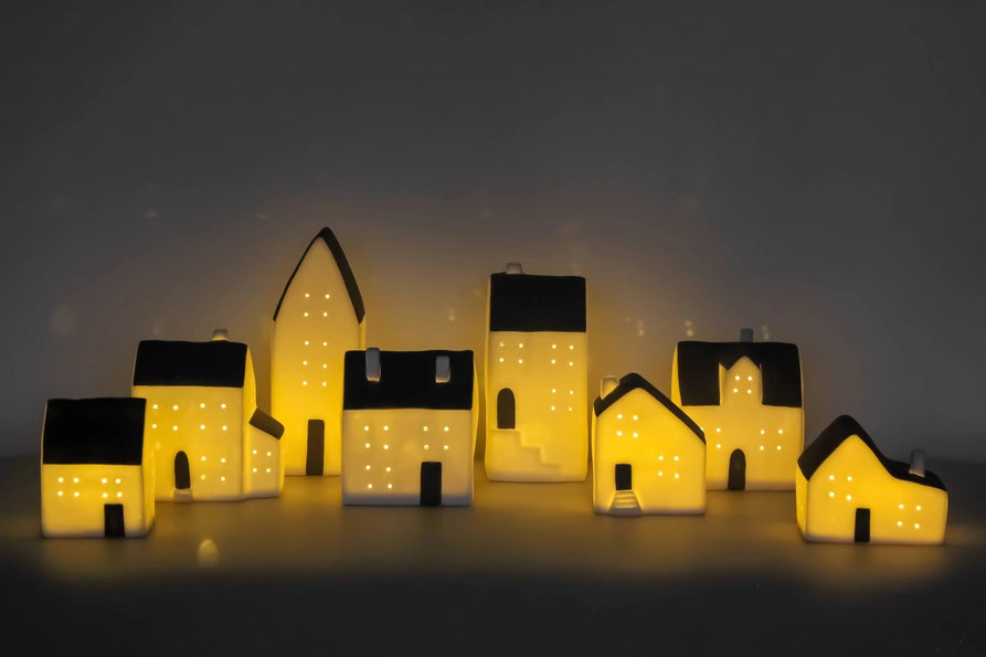 Set of illuminated house-shaped lights on a dark background