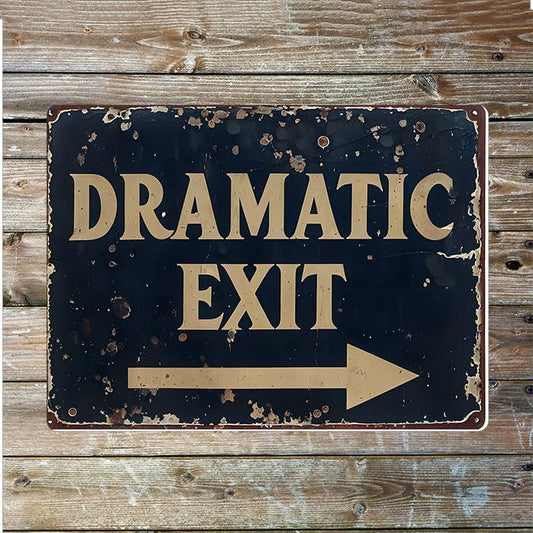 Vintage-style sign with 'Dramatic Exit' text on a wooden background
