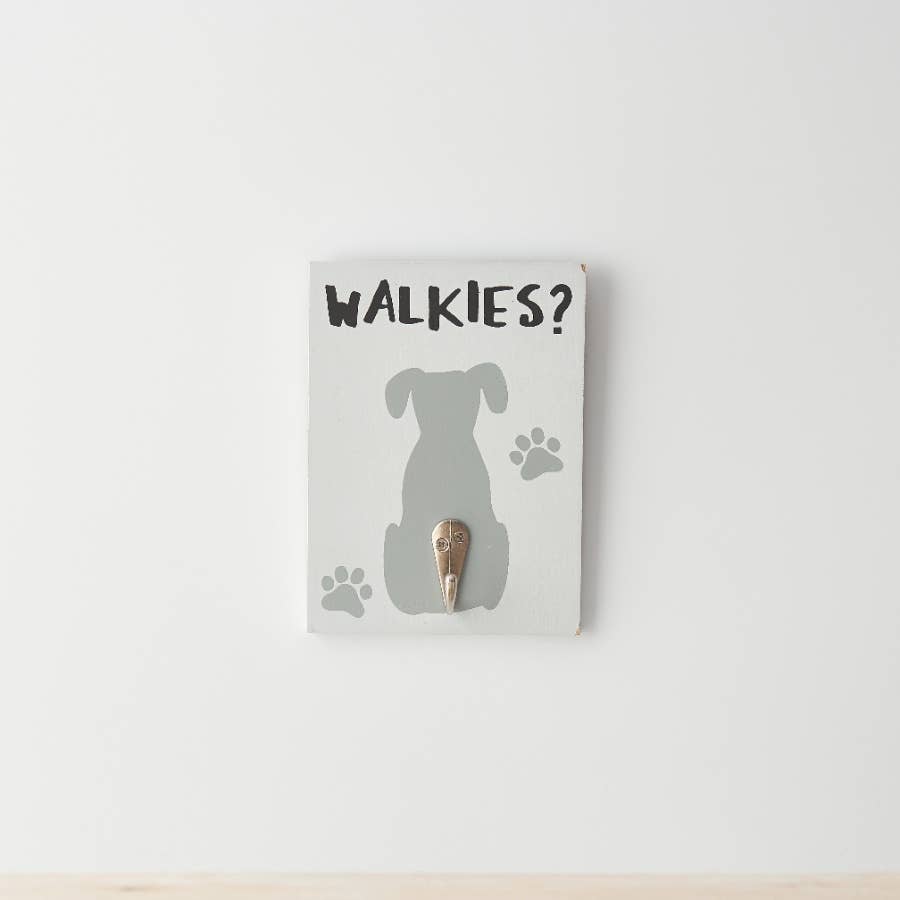 Decorative wall hook with dog silhouette and 'WALKIES?' text on a white background