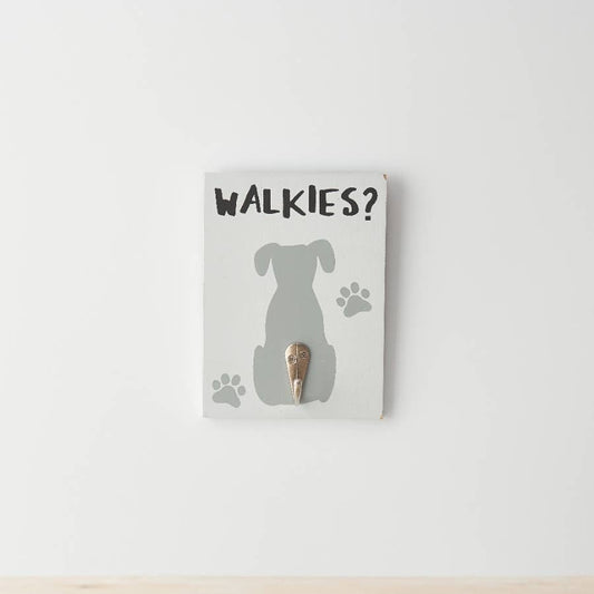 Decorative wall hook with dog silhouette and 'WALKIES?' text on a white background