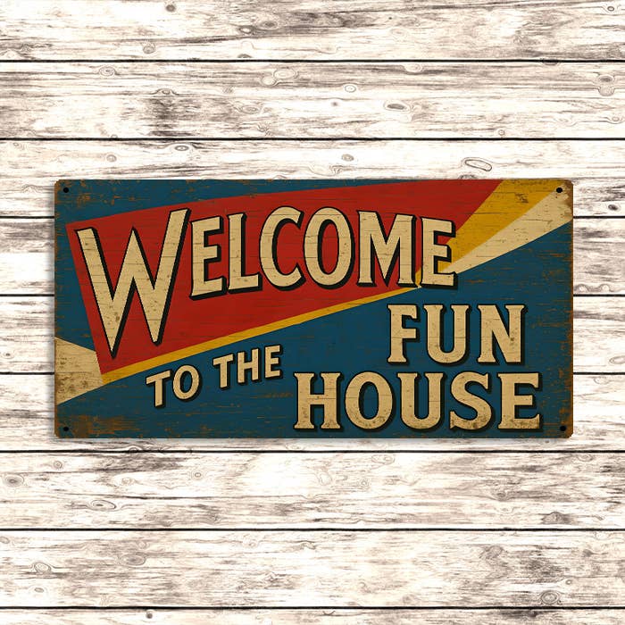 Vintage-style sign with 'Welcome to the Fun House' text on a wooden background