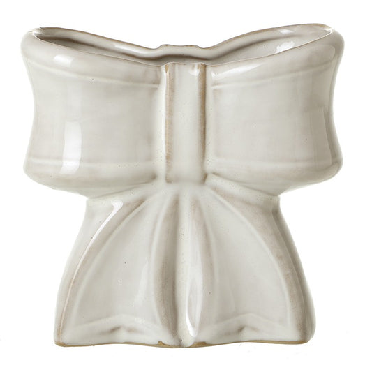 White ceramic bow-shaped vase on a white background