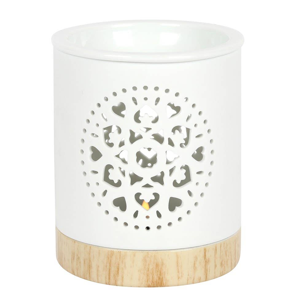 White ceramic lantern with wooden base and decorative cut-out pattern on a white background