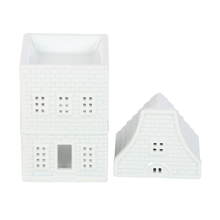 White ceramic nordic style wax warmer house with lid off on a white background