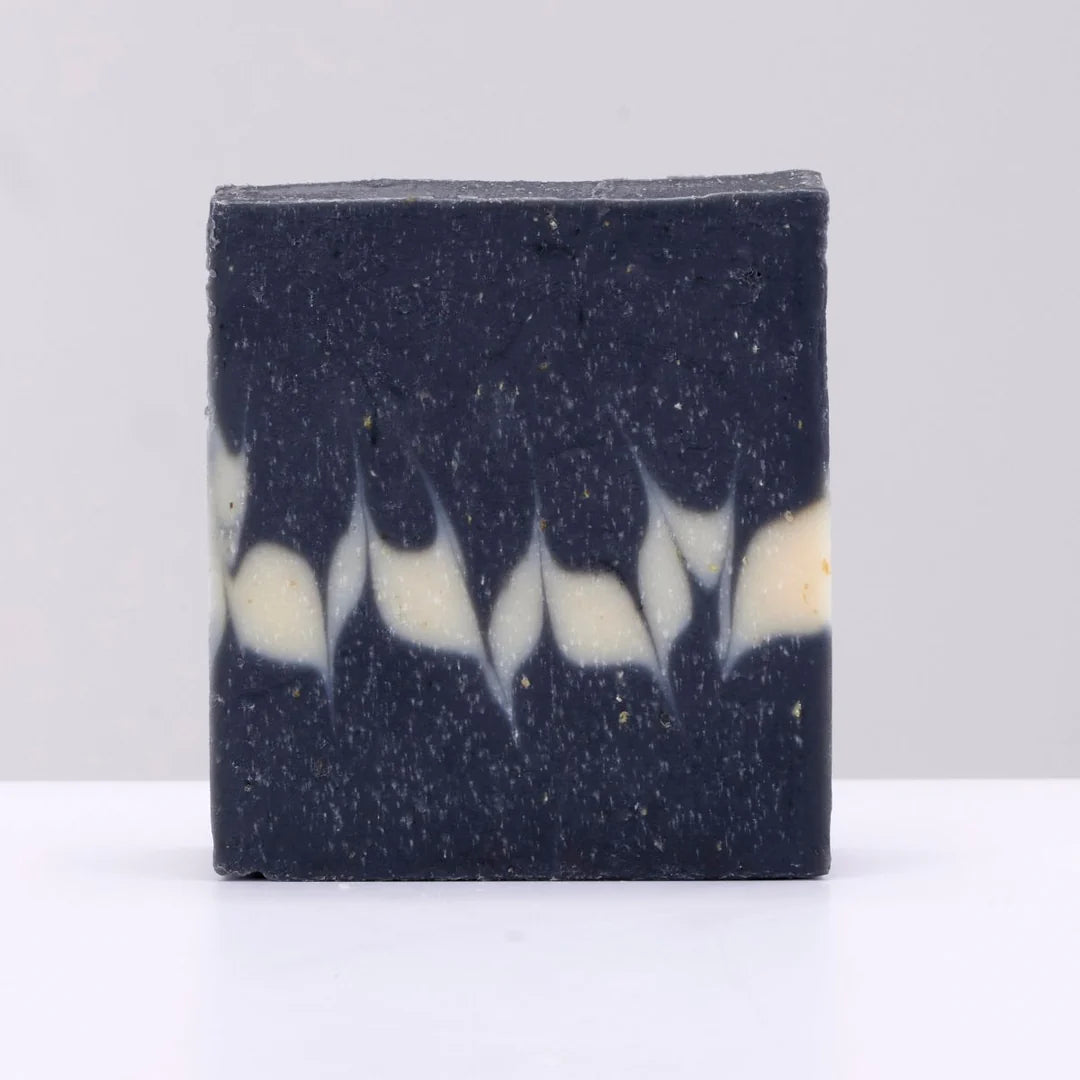 Black and white striped soap bar on a light gray background