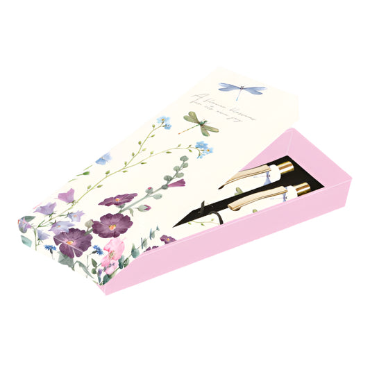 Floral-patterned box with a pen and small tool inside on a white background