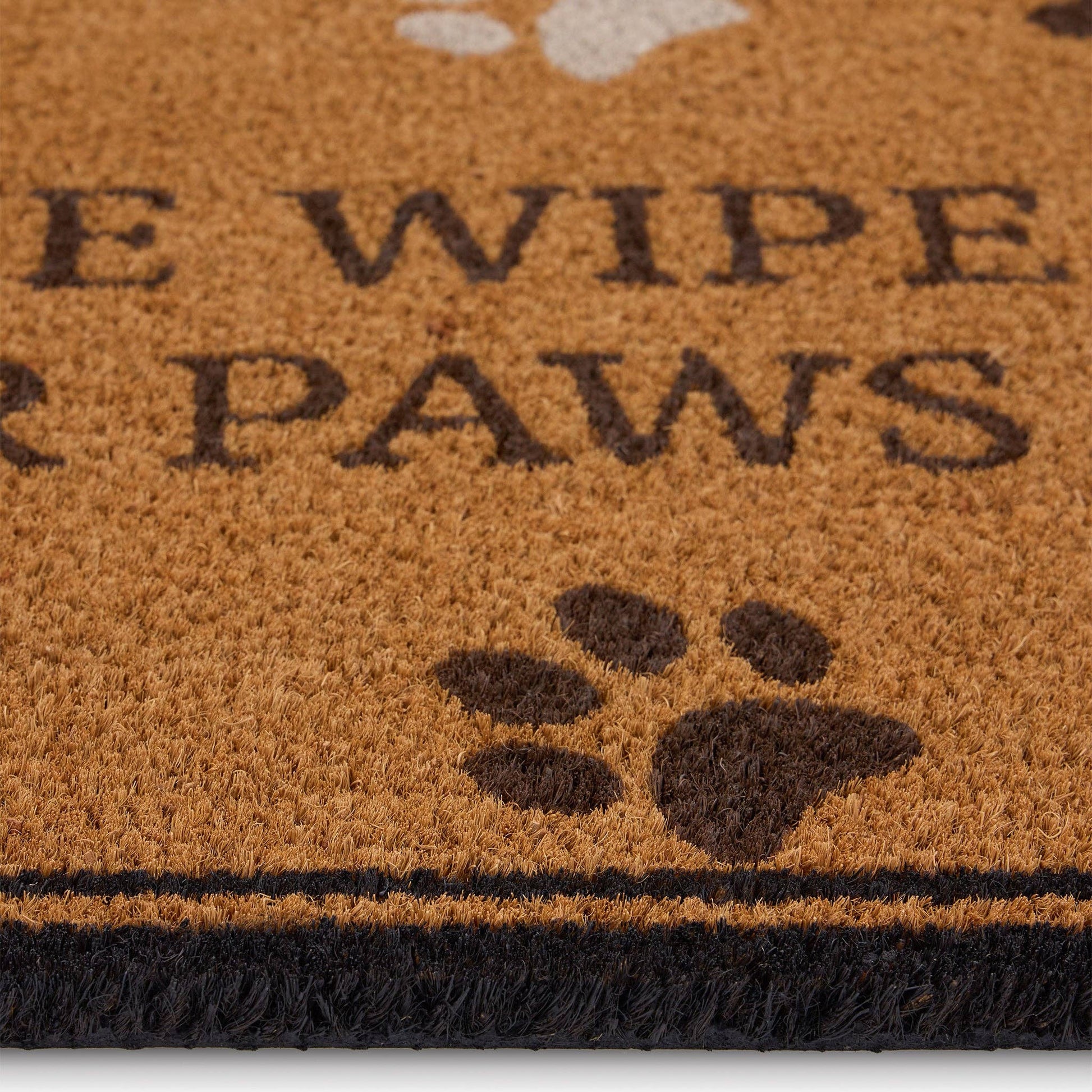 Doormat with 'Please wipe your paws' text and paw prints on a brown background