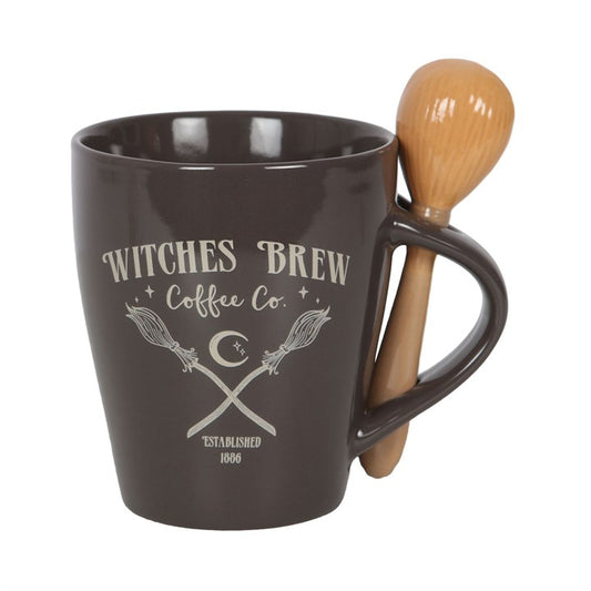 Brown mug with 'Witches Brew Coffee Co.' text and wooden spoon on a white background