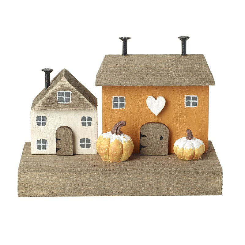 Decorative set of small houses with pumpkins on a white background