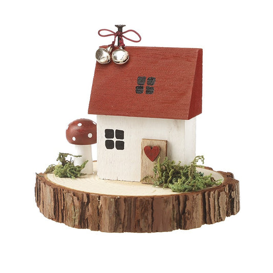 Decorative miniature house on a wooden base with a red roof and small windows.