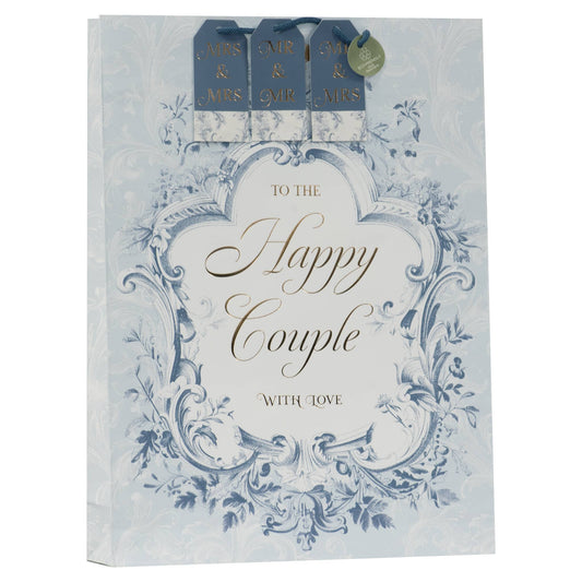 A square gift bag with a vintage-style blue and white floral design, featuring the text 'TO THE Happy Couple WITH LOVE' in elegant script. The top of the bag includes three blue gift tags reading 'AIR & MRS.