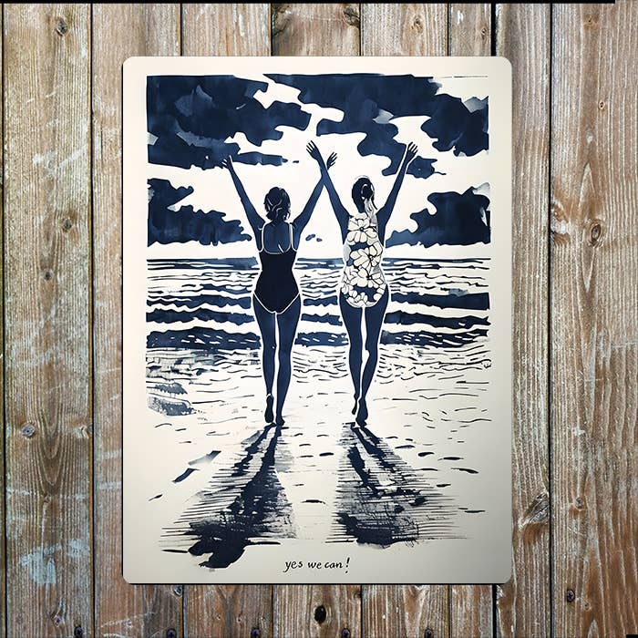 Artistic depiction of two people on a beach with 'yes we can!' text, on a wooden surface.