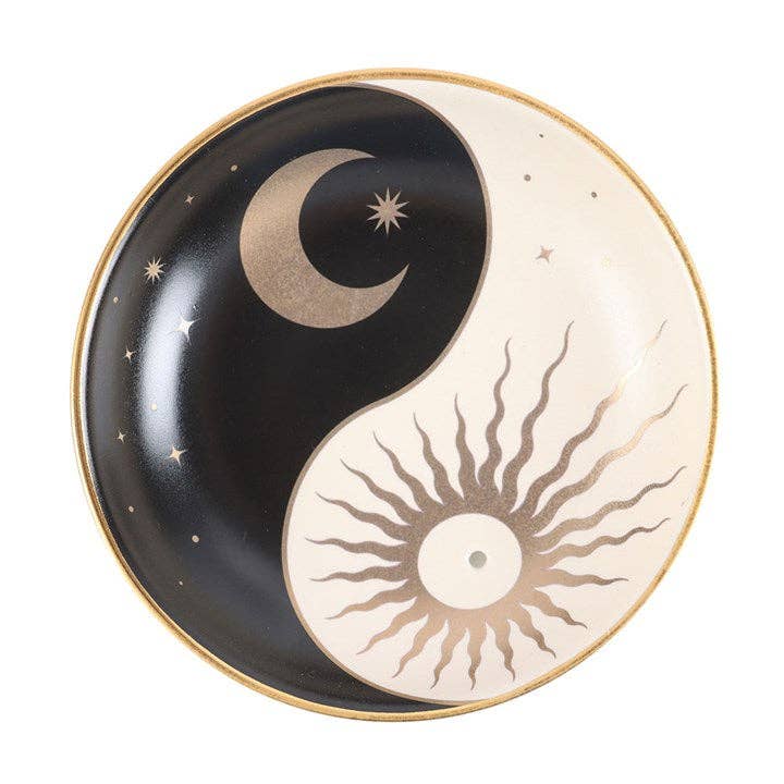 Decorative plate with yin yang design featuring a moon and sun on a black and white background.