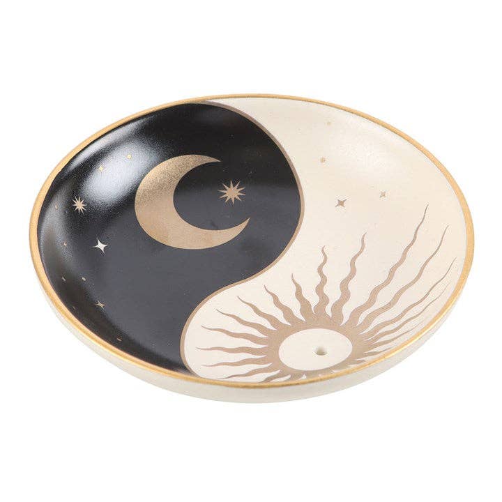 Decorative dish with yin yang design featuring a moon and sun.