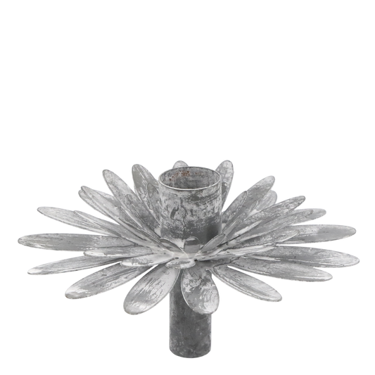 Decorative metal candle holder with a floral design on a white background