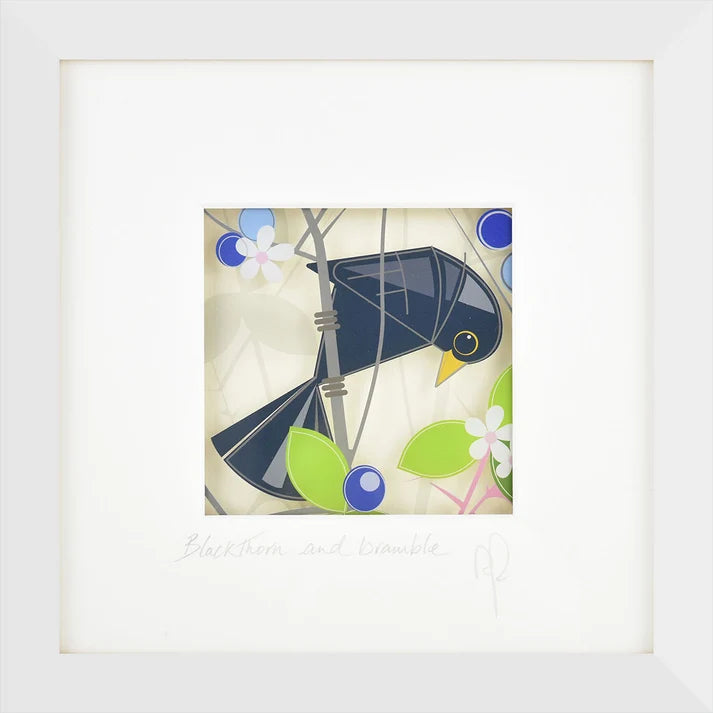 A framed art print featuring a stylized black bird perched on a branch with green leaves and blue flowers on a cream background, with the title 'Blackthorn and Trouble' and a signature printed below.