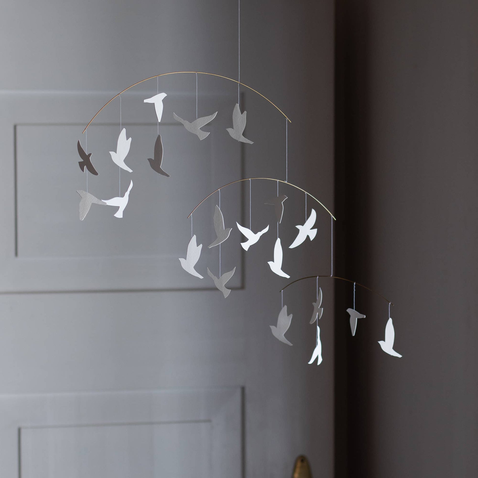 Decorative wall art of white birds on a white wall 