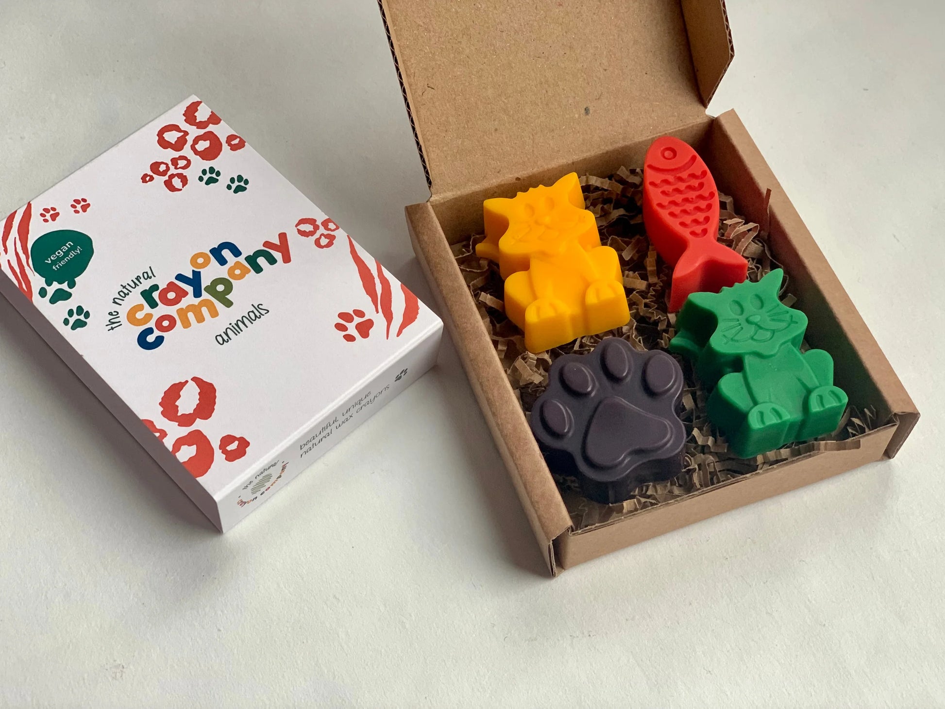 Colorful cat crayon set in a box with a branded box on a white background
