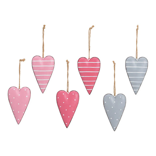 Set of hanging heart-shaped decorations with striped and polka dot patterns on a white background.