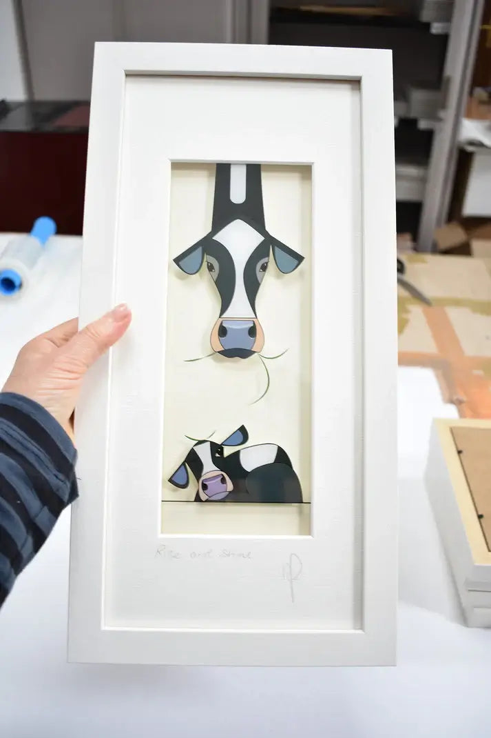 Rise & Shine. Image of cows being held